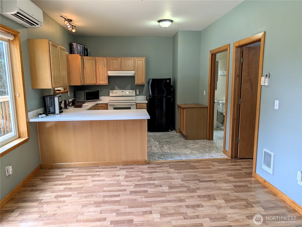 ADU kitchen wide view with peninsula counter and mini-split