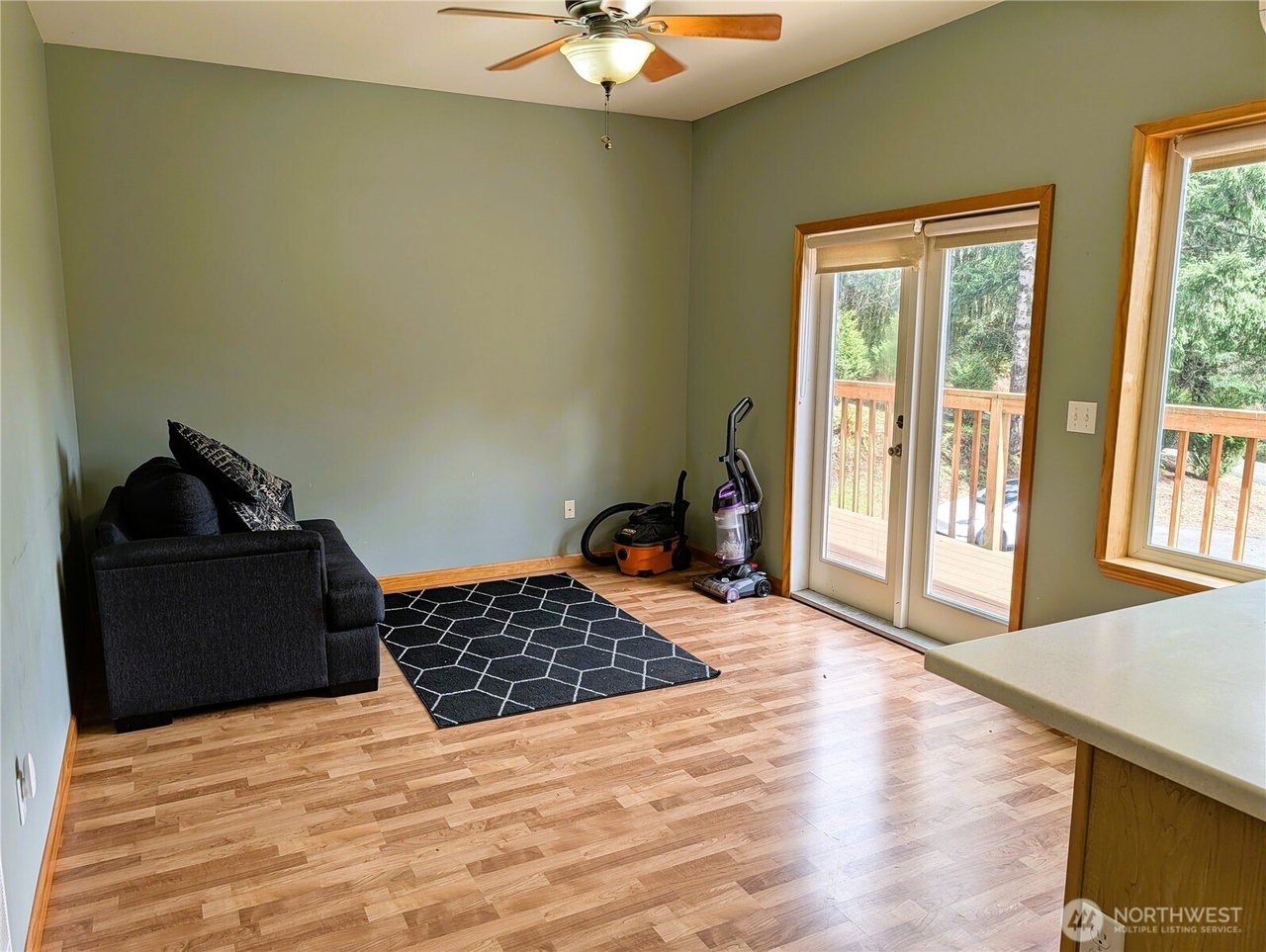 ADU living area with ceiling fan and French doors