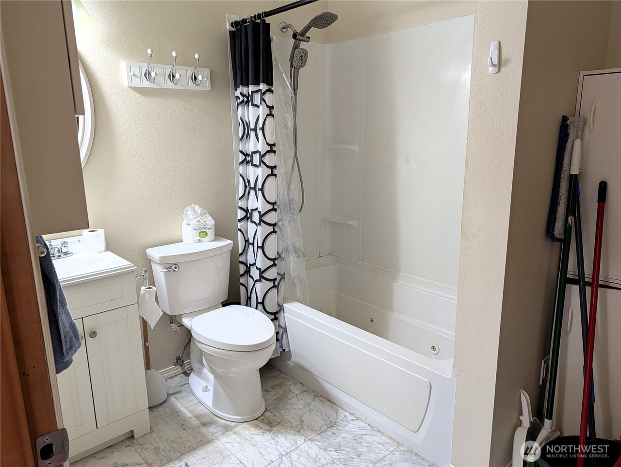 ADU bathroom with tub/shower and white vanity